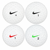 Four assorted Nike golf balls in white, with black, red and green swoosh logos