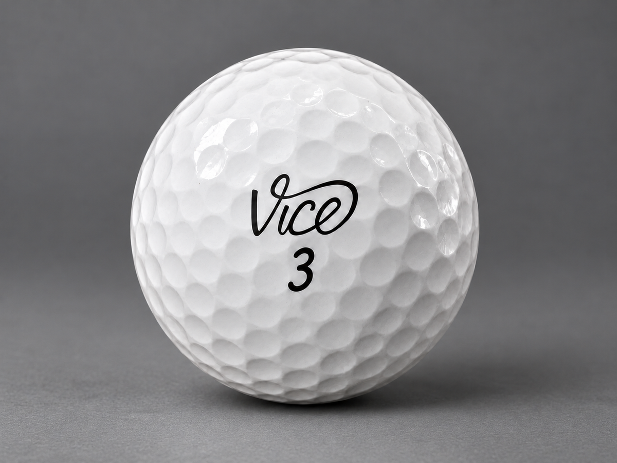 Clean white Vice golf ball on a graphite gray surface