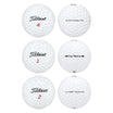 Six assorted white Titleist golf balls, including NXT Tour and Tour Prestige, in a two-by-three grid